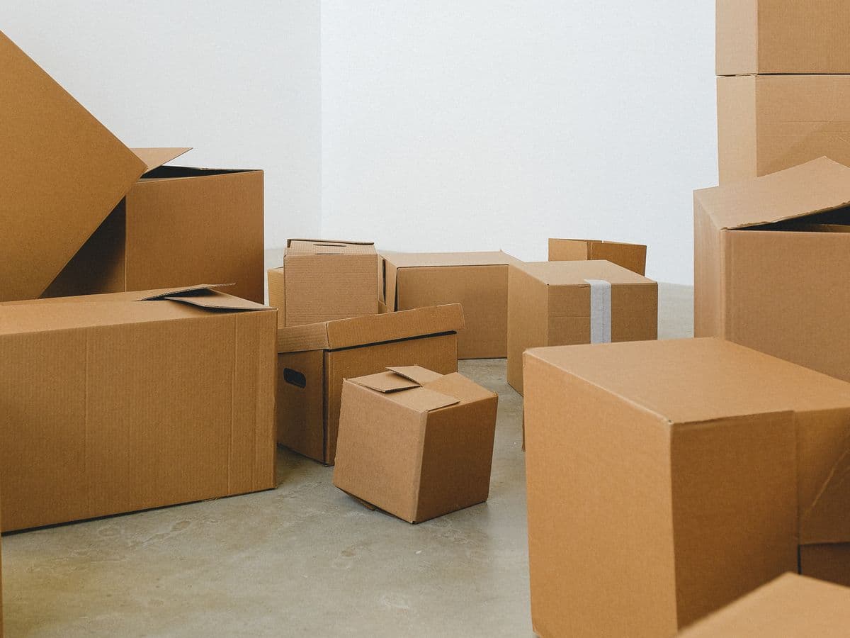 Neatly stacked packed cardboard moving cartons in an empty room